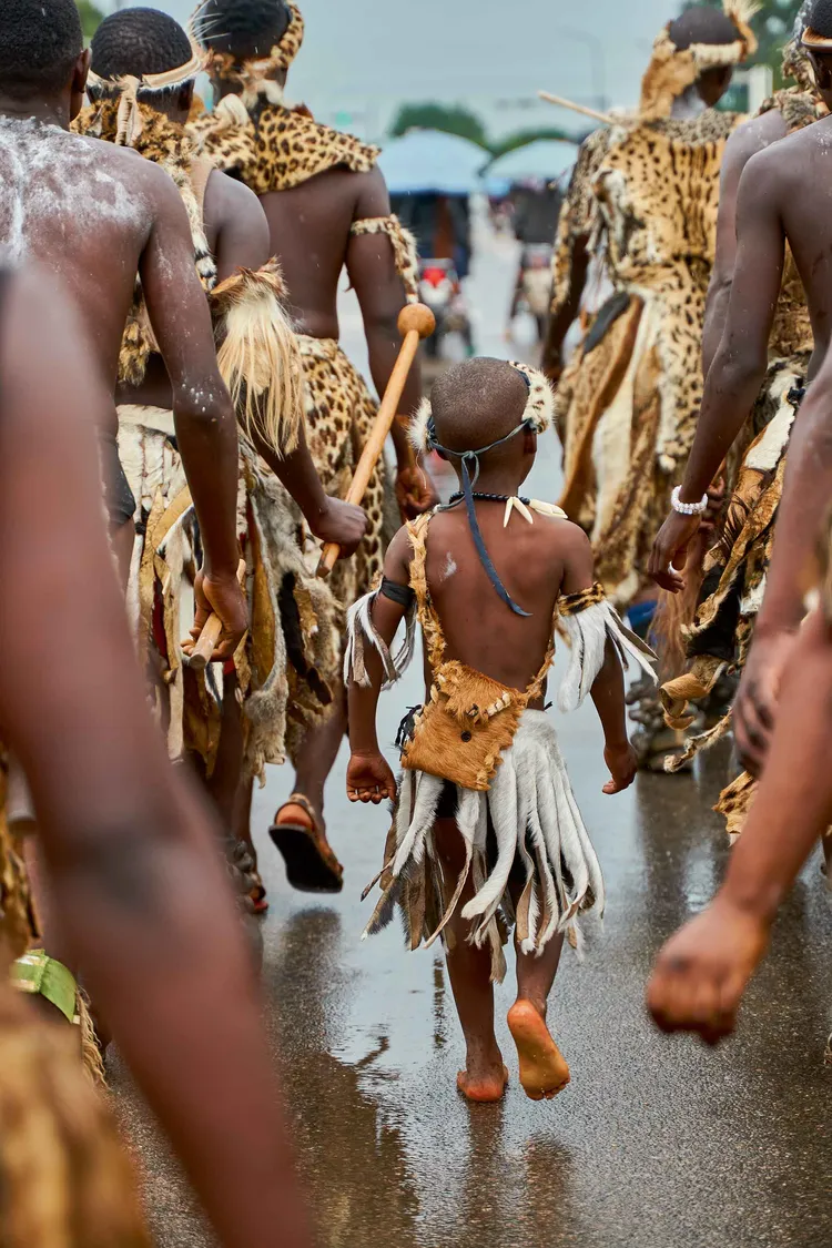 A young Ngoni boy walks amidst the carnival of faces in Chipata town. (Image by Lint Studios for Nkwazi Magazine).