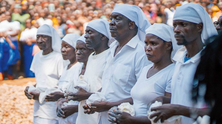 Elders stand in a disciplined line, ulupemba (white chalk) in hand, poised to bless the king and mark him as purified by the ancestors. (Image by Chona Mweemba for Nkwazi Magazine).