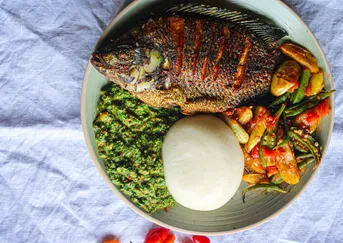 Nshima with fish and visashi. Image Courtesy of Black Garlic (Clara Kapelembe Bwali).