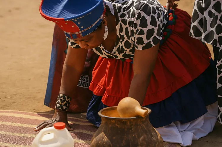 Chieftainess bowing down to pray for rains. (Image is artists impression).