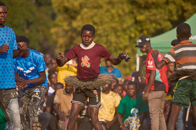 Tundanji perform kuhunga: a special dance performed by nitiates who have healed and bathed for the first time. Their kilts (jizombo) are made from the bark of the mulende tree. (Image by Nkwazi/Justine Kunda).(Image by Nkwazi/Justine Kunda).